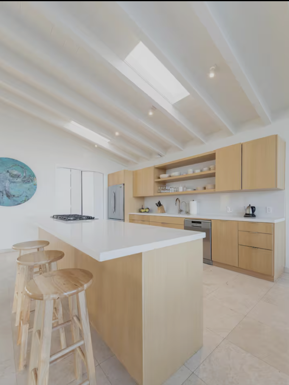 Light wood kitchen with a large white island
